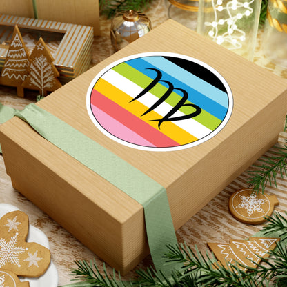 Gift box with a green ribbon on a festive background with cookies and Christmas decorations. Virgo Queer pride sticker centered on the box.