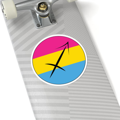 Close-up of the bottom of a silver skateboard featuring a 6 inch by 6 inch circular zodiac sticker with a centered Sagittarius glyph on a Pansexual pride flag style background applied to the surface.