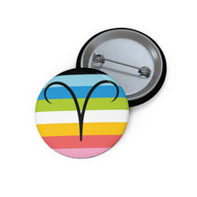 Front and back view of a circular queer pride flag button featuring the Aries zodiac symbol in black centered on the front.