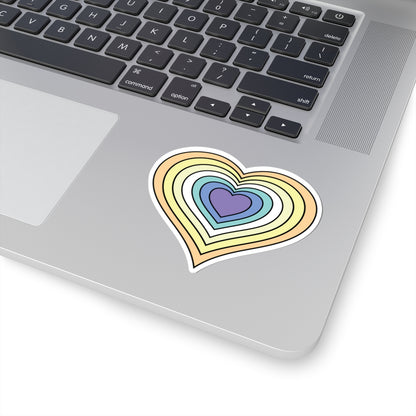 Close-up of the bottom right corner of a silver laptop featuring a 3 inch by 3 inch pride flag heart sticker in a Genderfaun flag style applied to the surface.