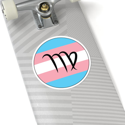 Close-up of the bottom right corner of a silver laptop featuring a 6 inch by 6 inch circular zodiac sticker with a centered Virgo glyph on a Transgender pride flag style background applied to the surface.