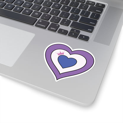 Close-up of the bottom right corner of a silver laptop featuring a 3 inches by 3 inches pride flag heart sticker in a Drag pride flag style applied to the surface.