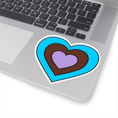 Close-up of the bottom right corner of a silver laptop featuring a 4 inch by 4 inch pride flag heart sticker in an Androsexual flag style applied to the surface.