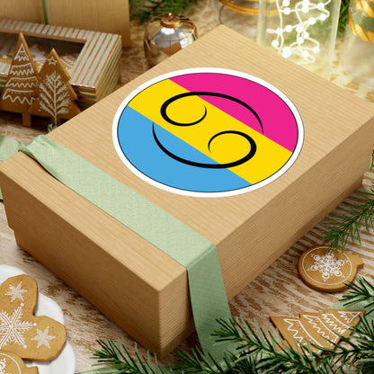 Gift box with a green ribbon on a festive background with cookies and Christmas decorations. Cancer Pansexual pride sticker centered on the box.