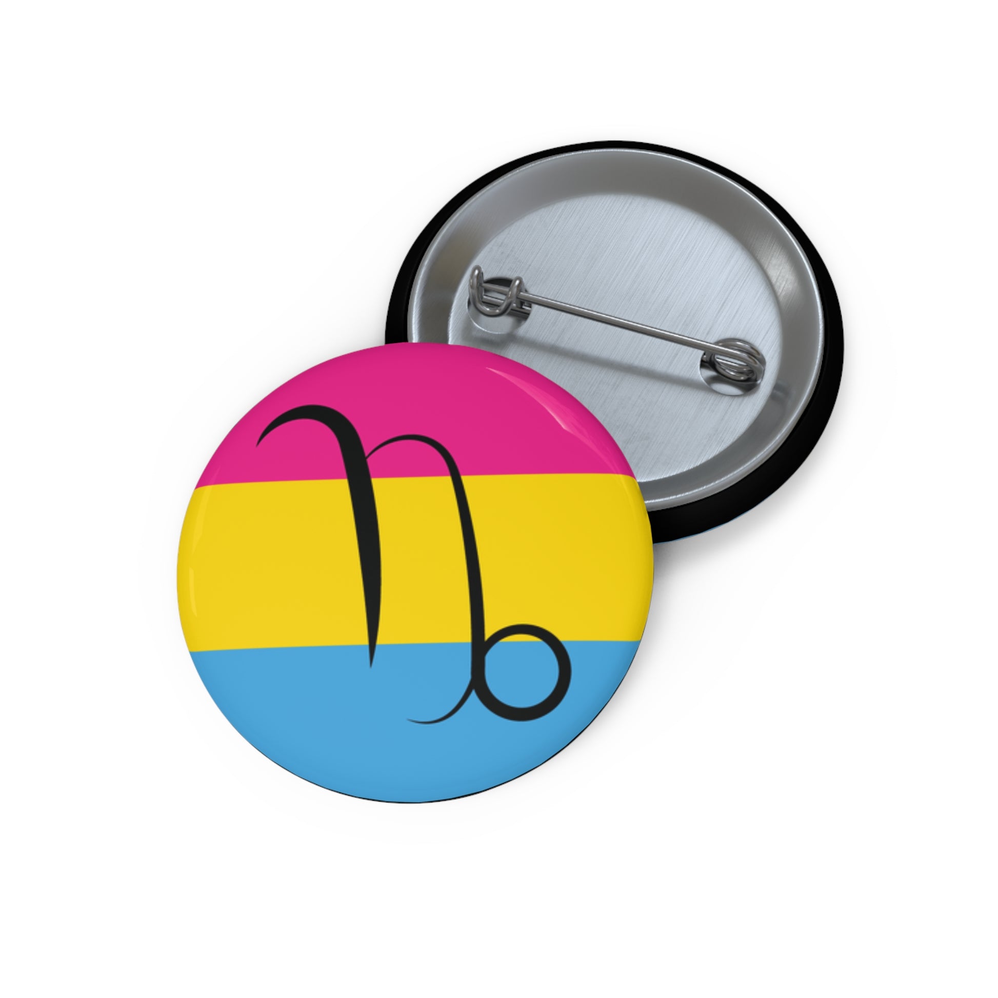 Front and back view of a circular pansexual pride flag button featuring the Capricorn zodiac symbol in black centered on the front.