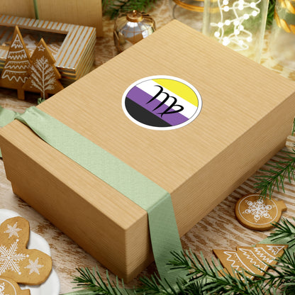 Gift box with a green ribbon on a festive background with cookies and Christmas decorations. Virgo Nonbinary pride sticker centered on the box.